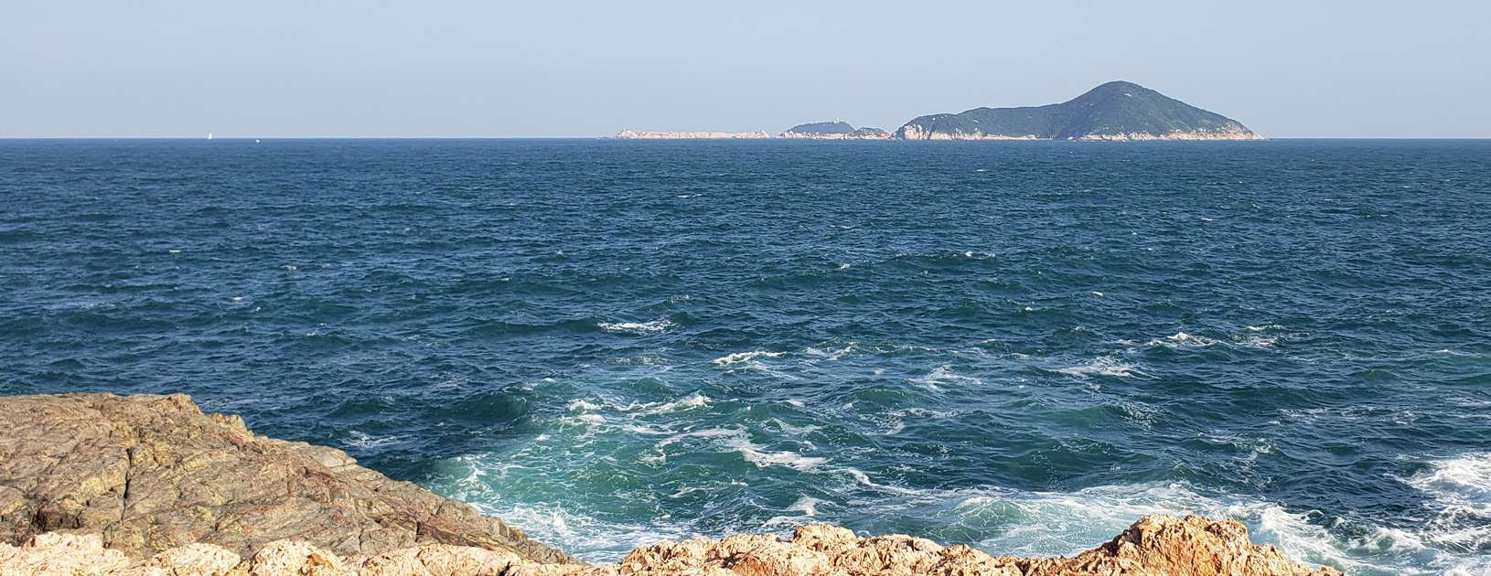 Waglan Island seen from the shore of Cape D’Aguilar.